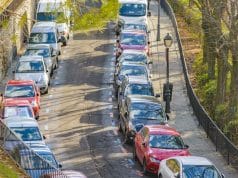Parked cars in the streets of Madrid in orange and blue lines.