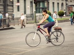 Cyclist on Calle Alcalá, Madrid and pedestrians behind.